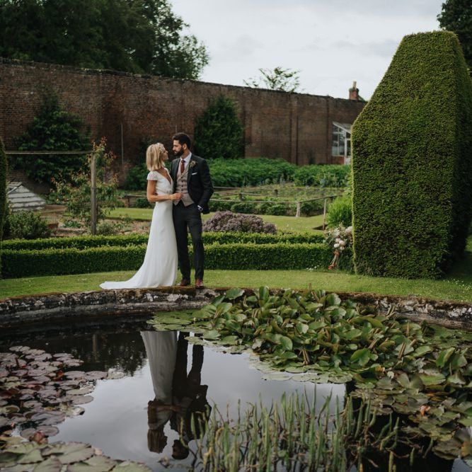 Bride and groom embrace in the gardens at Newburgh Priory for outdoor wedding