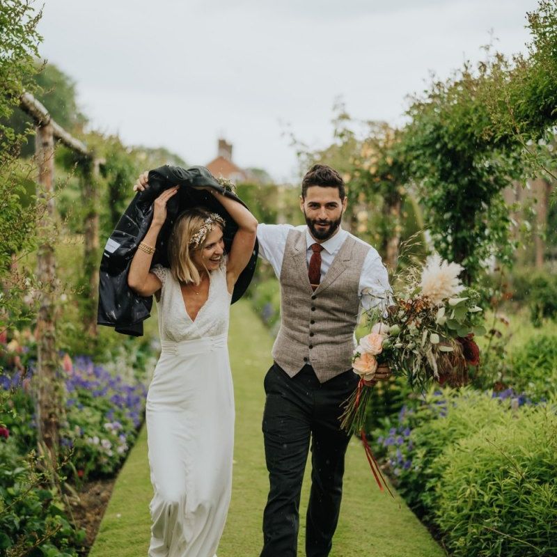 Bride and groom get caught in the rain at spring wedding in Yorkshire