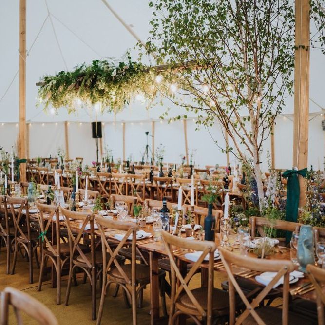 Marquee decor with white floral and foliage decor with gold touches