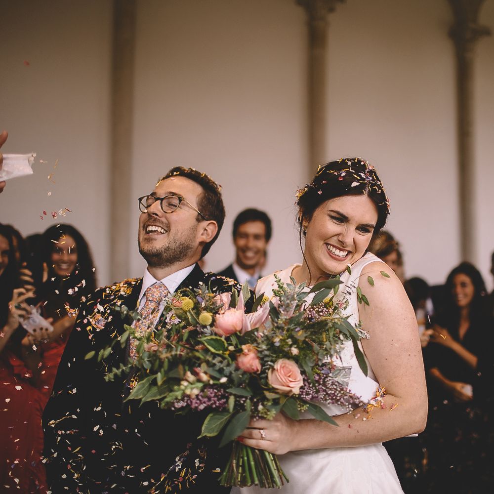 Bride and Groom Laughing During Confetti Moment