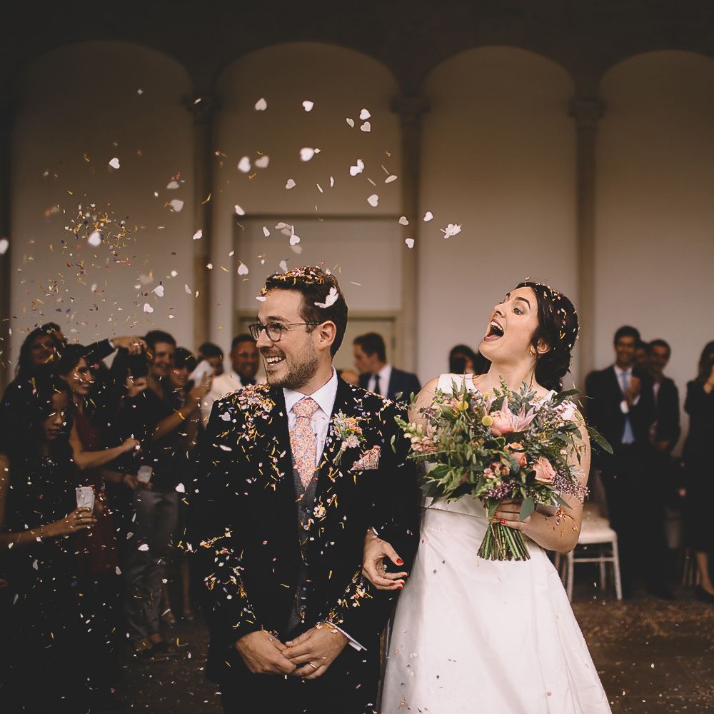 Bride and Groom Having Confetti Thrown Over Them