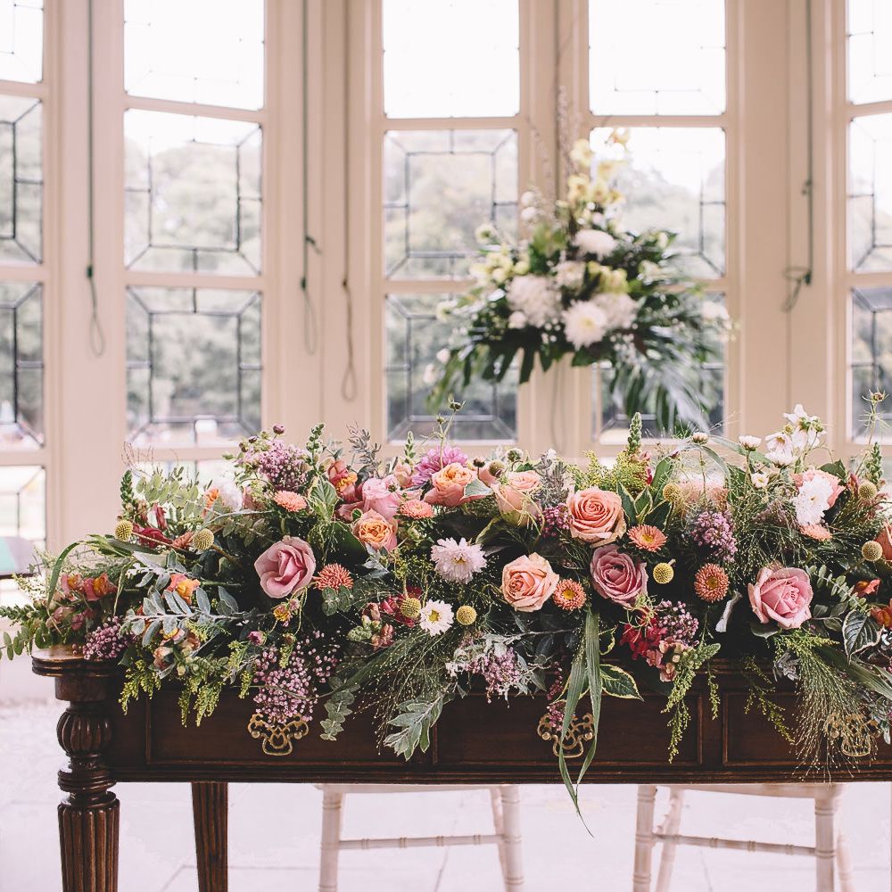 Wedding Floral Arrangement with Foliage and Pink and Peach Roses
