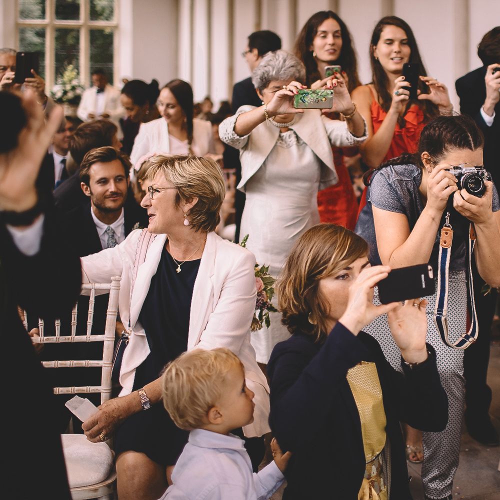 Wedding Guests Taking Pictures of The bride and Groom