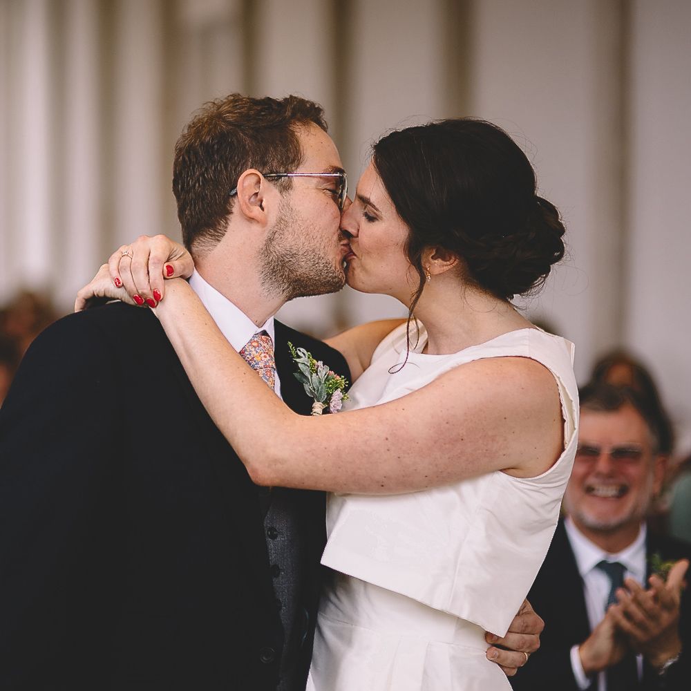 Bride and Groom Kissing During The Wedding Ceremony