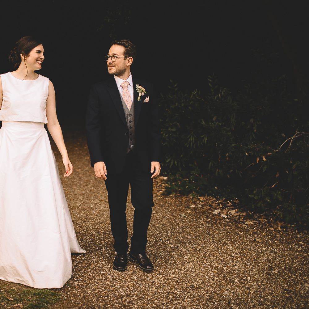 Bride in Homemade Wedding Dress with Layered Top and Bow Back and Groom in Dress2Kill Suit