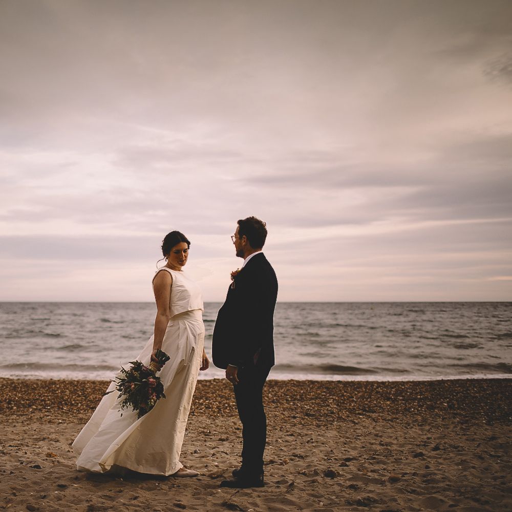 Coastal Portrait of Bride in Homemade Wedding Dress with Bow Back and Groom in Dress2Kill Suit