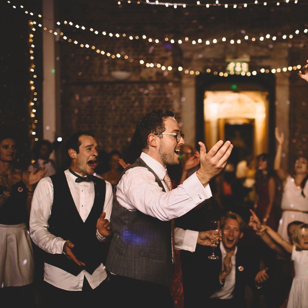 Bride and Groom Dancing at Evening Reception with Fairylight Backdrop
