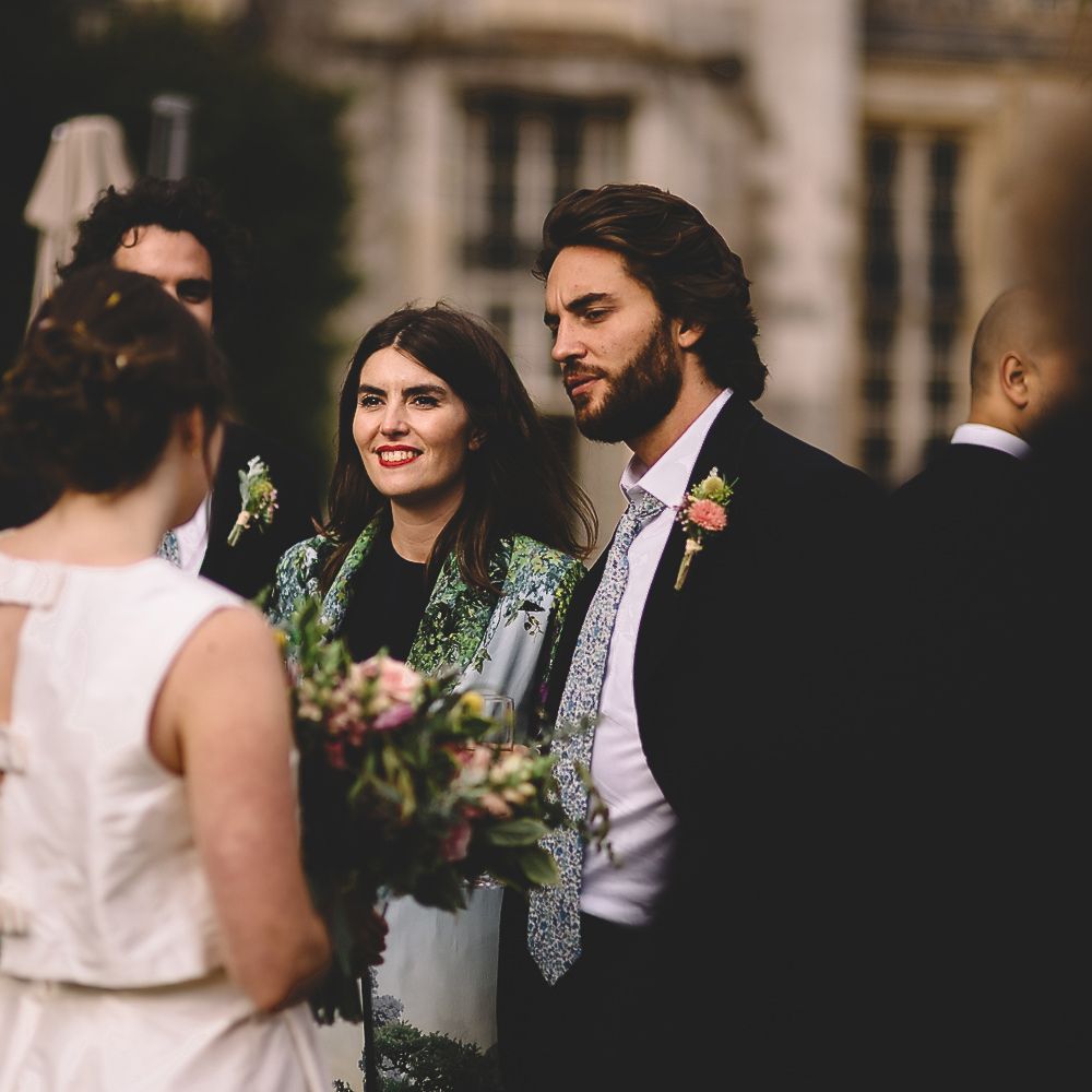 Bride in Homemade Wedding Dress with Bow Back Detail Talking to Wedding Guests