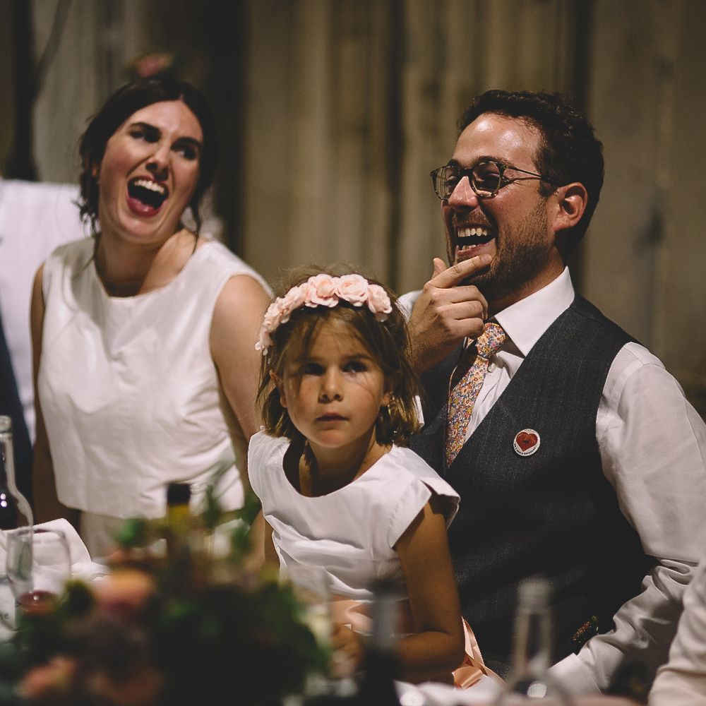 Bride and Groom Laughing During The Wedding Speeches