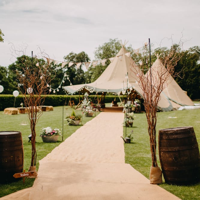Tipi Entrance with Barrels &amp; Bunting &amp; Festoon Lights  | DIY Rustic Tipi Wedding at Riverhill Gardens, Sevenoaks | Frances Sales Photography