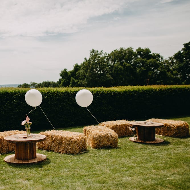 Hay Bale Seating Area with Giant Balloon Wedding Decor | DIY Rustic Tipi Wedding at Riverhill Gardens, Sevenoaks | Frances Sales Photography