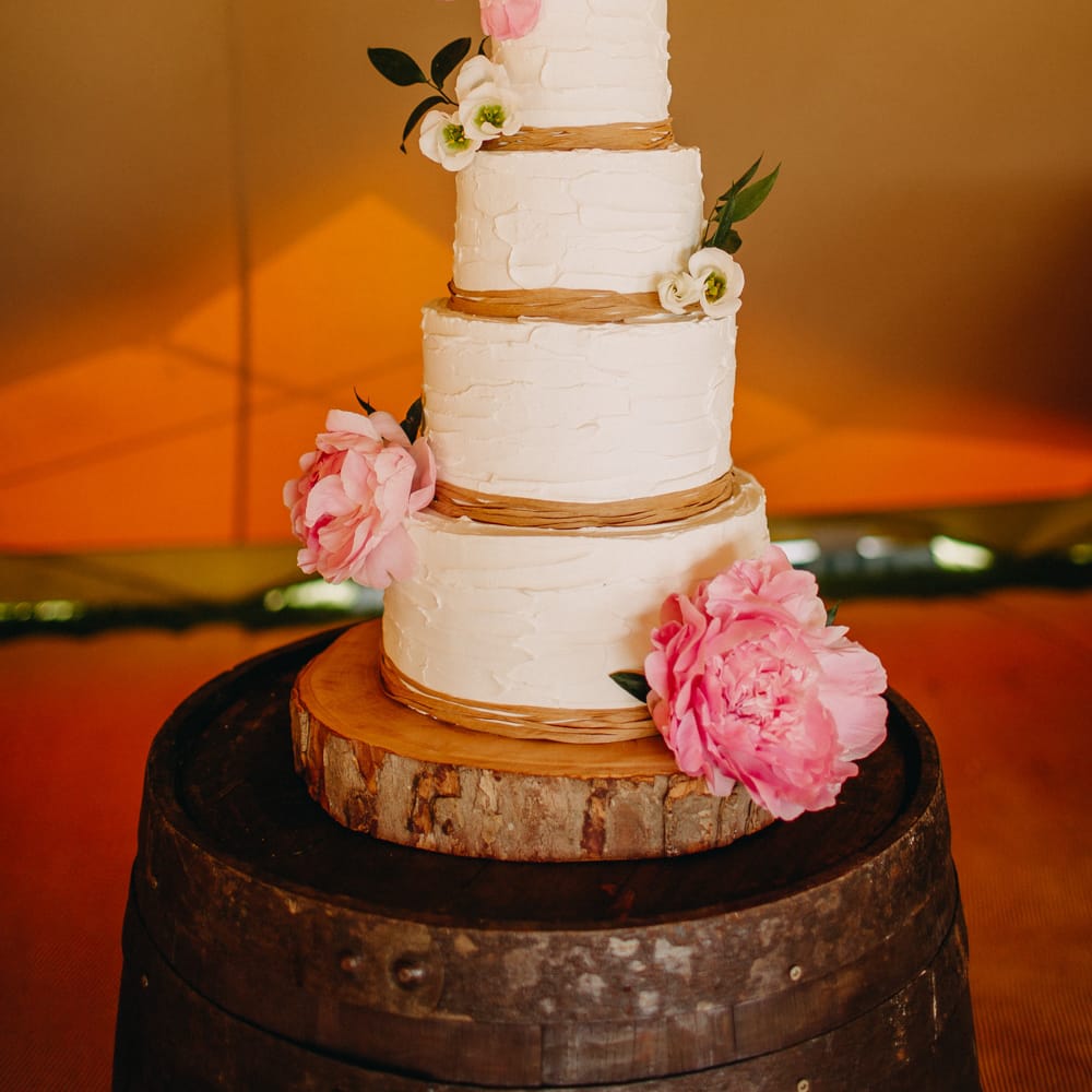 Cream Frosting Wedding Cake on Tree Slice Cake Stand | Wedding Decor | DIY Rustic Tipi Wedding at Riverhill Gardens, Sevenoaks | Frances Sales Photography