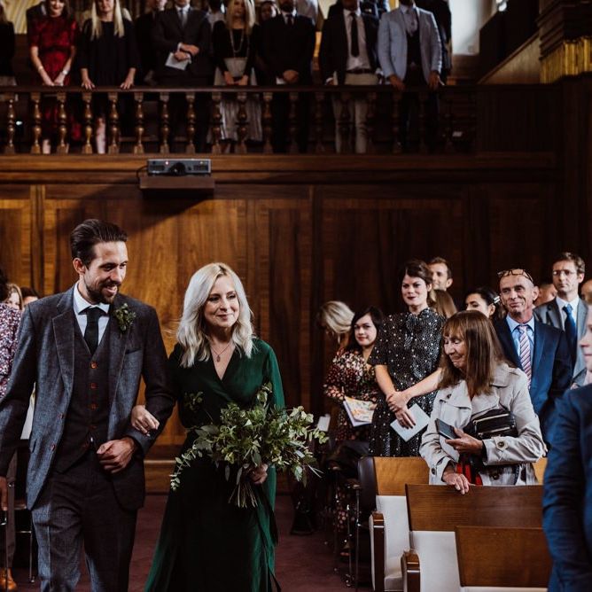 Bridesmaid wearing emerald green dress and foliage bouquet at Stoke Newington Town Hall wedding