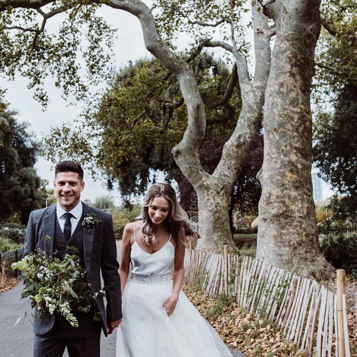 Bride wearing two piece dress and groom wearing three piece 'Peaky Blinder' style suit