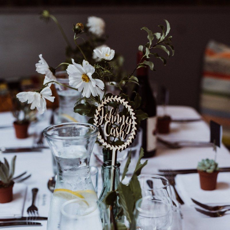 Laser cut signs and glass vases with floral arrangements