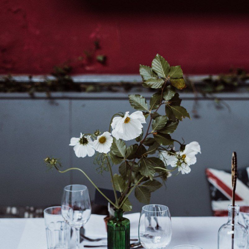 Glass vases with floral centrepieces at pub reception