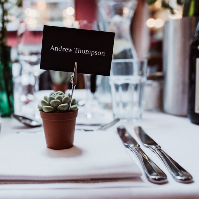 Succulent plant place settings at pub reception with foliage decor