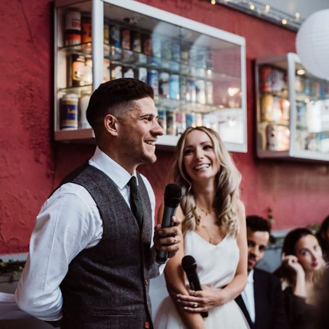 Bride and groom enjoy the toasts at relaxed party pub reception