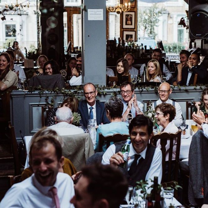 Guests raise a glass at pub reception for a relaxed party celebration