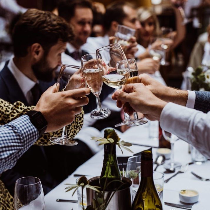 Guests raise a glass at pub reception for a relaxed party celebration