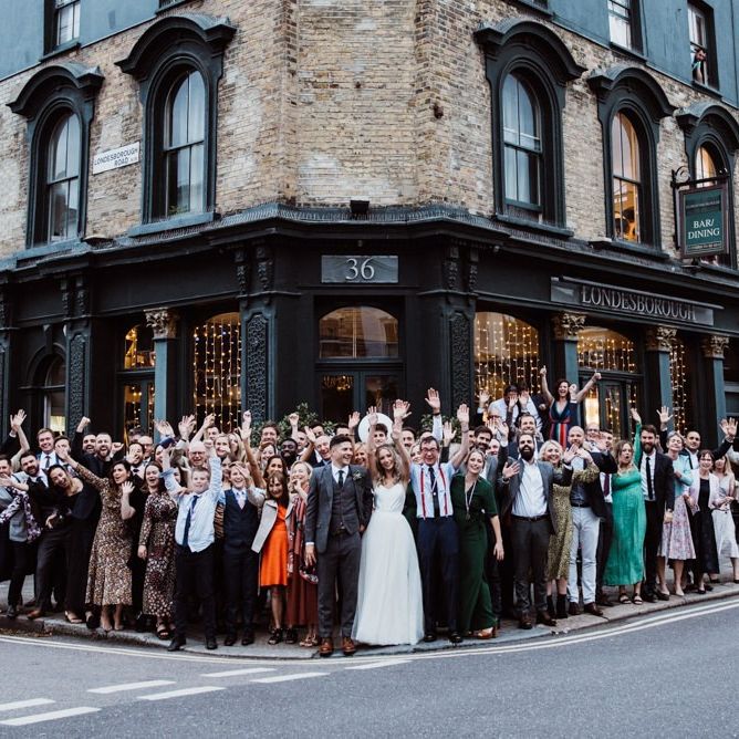 Bride and groom celebrate with their guests at pub reception