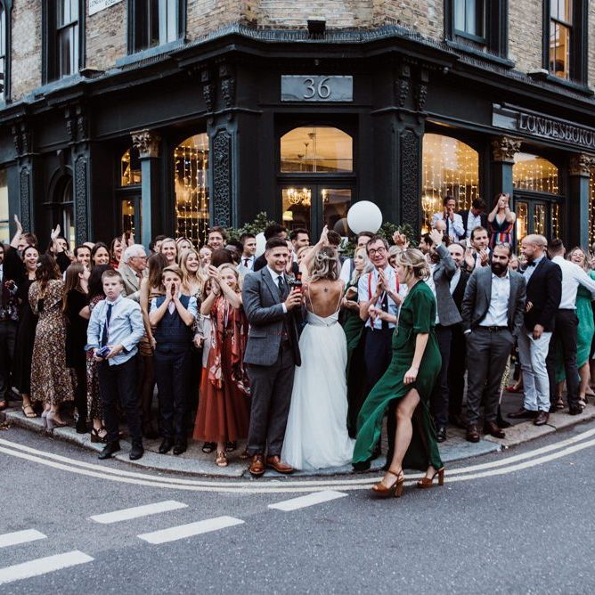 Bride and groom celebrate with their guests at pub reception