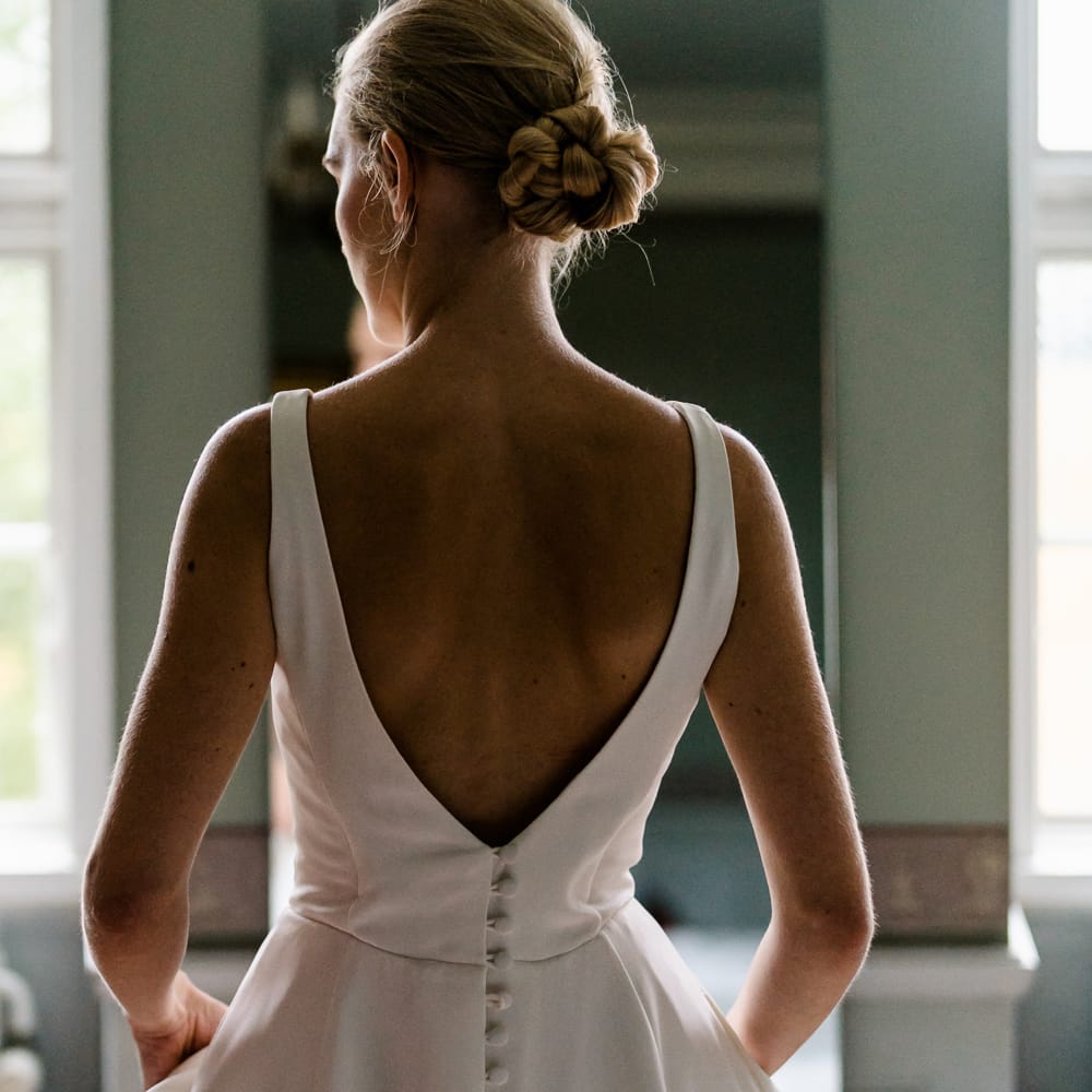 Elegant Bride in Caroline Castigliano Wedding Dress with Buttons on the Back | Traditional Green/Blue Danish Wedding at Scandinavian Country House, Jomfruens Egede in Faxe, Denmark | John Barwood Photography