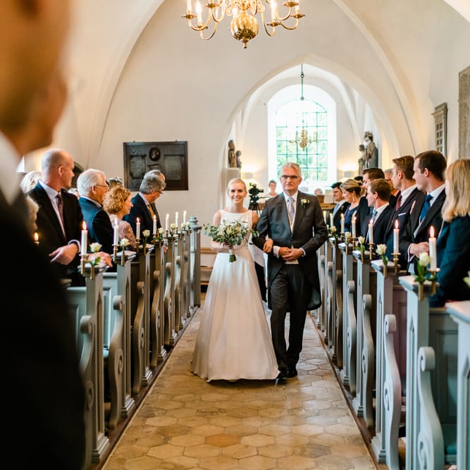 Church Wedding Ceremony | Bridal Entrance  in Caroline Castigliano Wedding Dress | Traditional Green/Blue Danish Wedding at Scandinavian Country House, Jomfruens Egede in Faxe, Denmark | John Barwood Photography