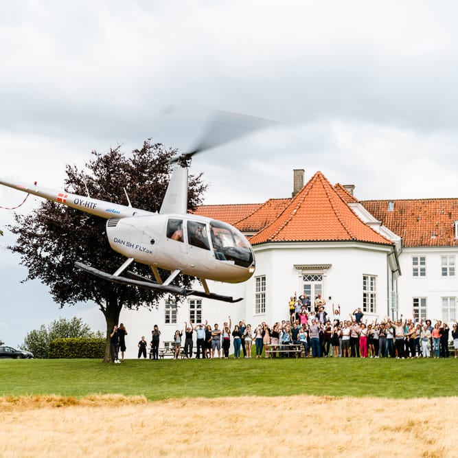 Helicopter Entrance | Traditional Green/Blue Danish Wedding at Scandinavian Country House, Jomfruens Egede in Faxe, Denmark | John Barwood Photography