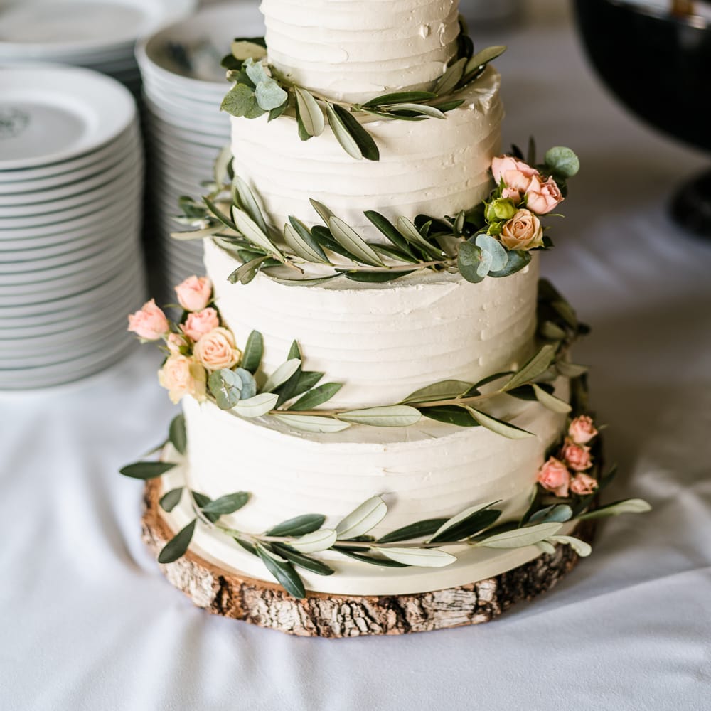 Cream Frosting Wedding Cake with Foliage &amp; Pink Flower Decor  | Traditional Green/Blue Danish Wedding at Scandinavian Country House, Jomfruens Egede in Faxe, Denmark | John Barwood Photography