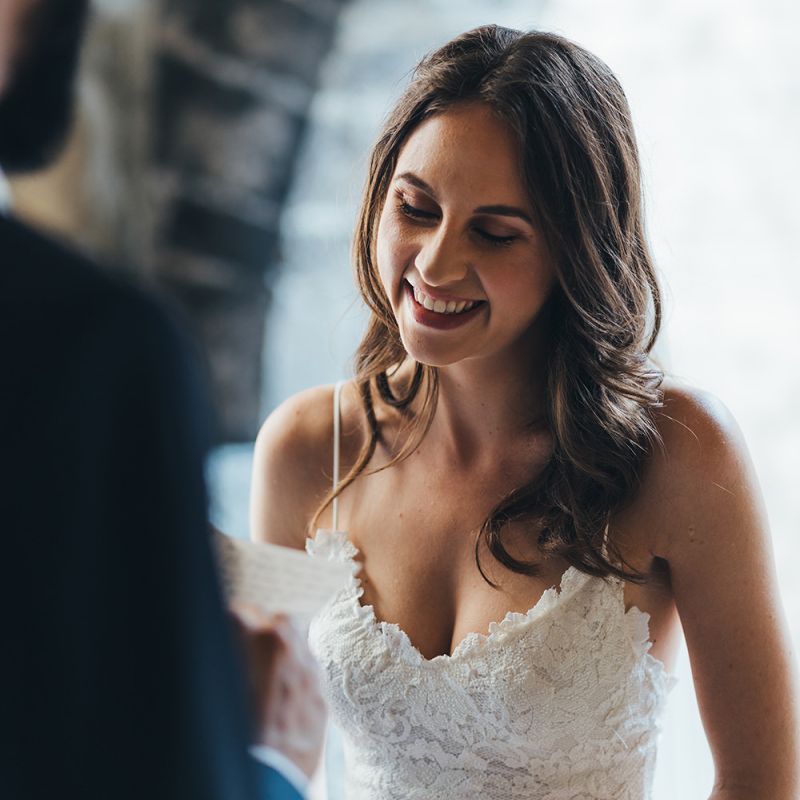 Happy Bride in Grace Loves Lace Mia Wedding Dress Listening to Her Grooms Vows