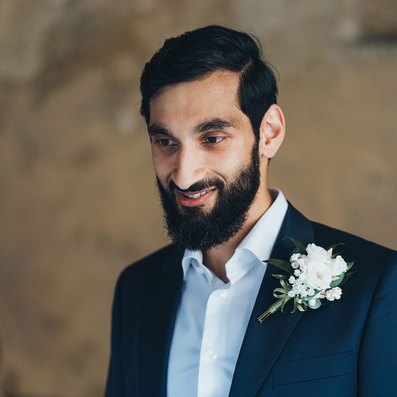 Groom in Taliare Navy Suit Reading His Vows