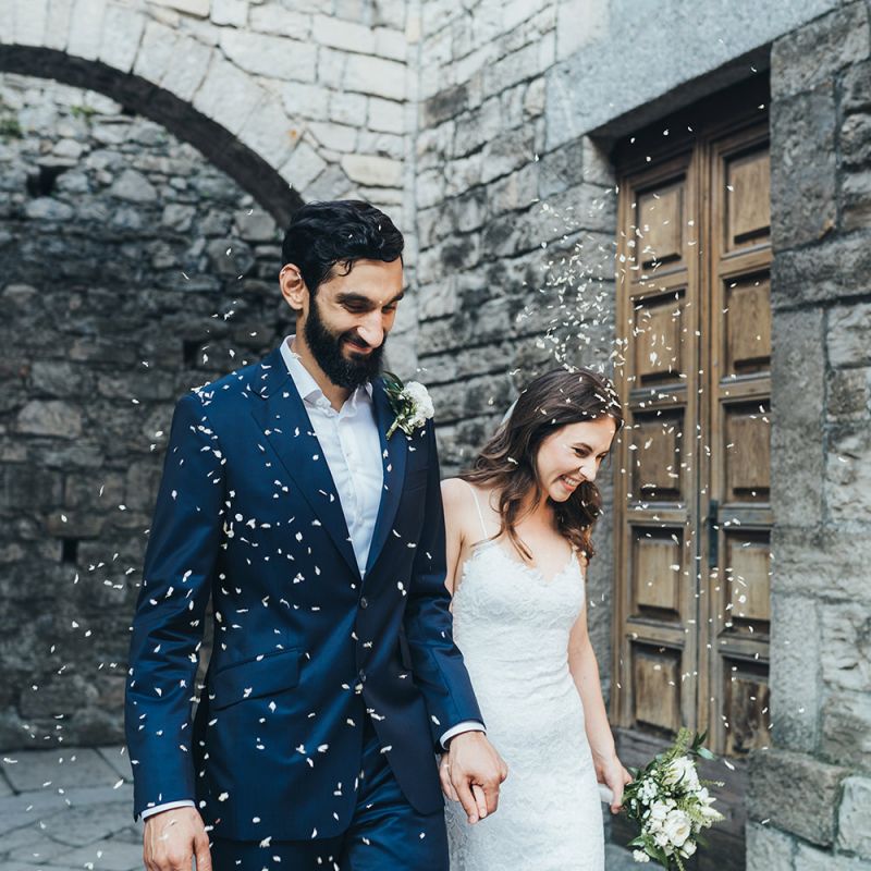 Confetti Exit with Bride in Grace Loves Lace Mia Wedding Dress and Groom in Taliare Navy Suit