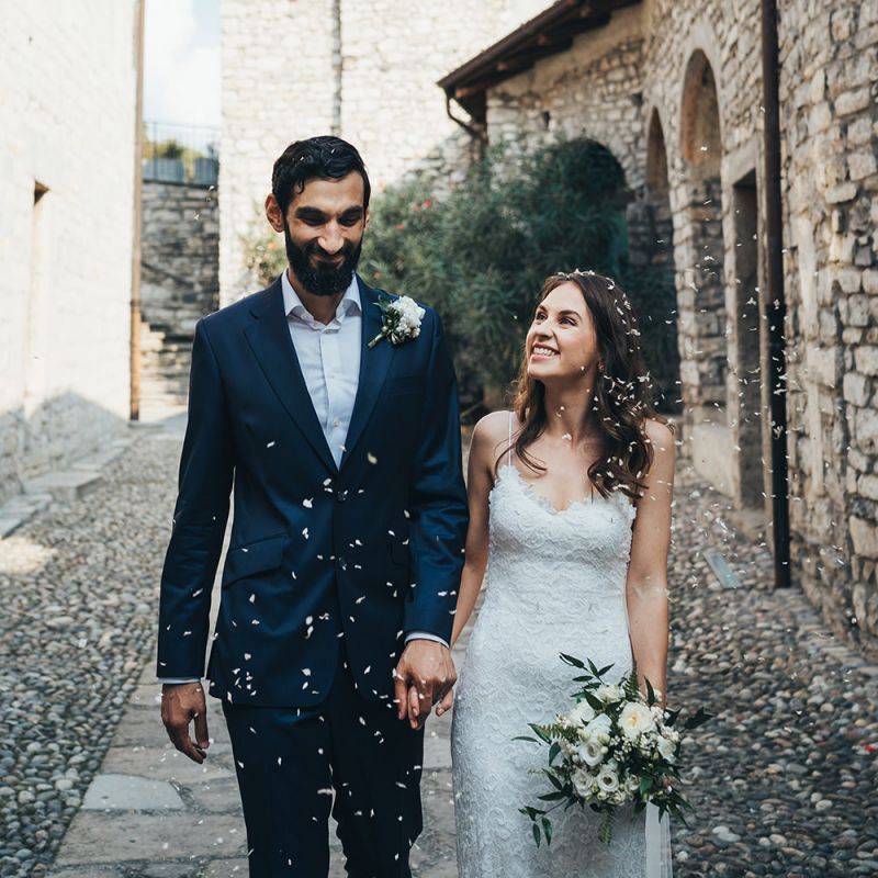Just Married Confetti Moment with Bride in Grace Loves Lace Mia Wedding Dress and Groom in Taliare Navy Suit
