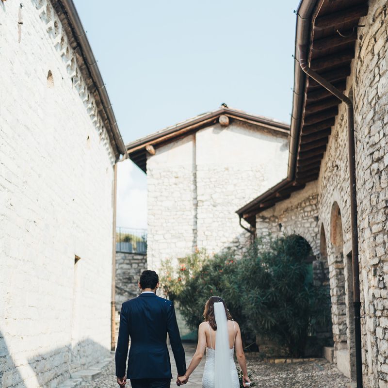 Bride in Grace Loves Lace Mia Wedding Dress and Groom in Taliare Navy Suit