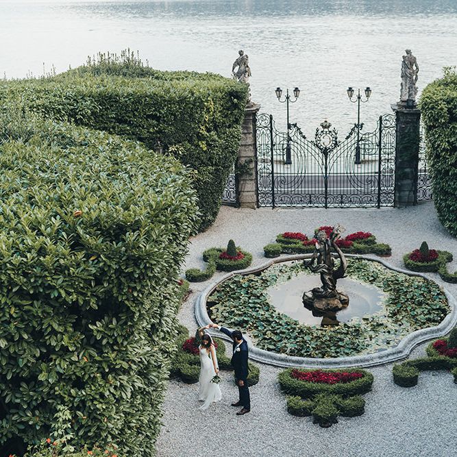 First Dance in a Garden with Bride in Grace Loves Lace Mia Wedding Dress and Groom in Taliare Navy Suit