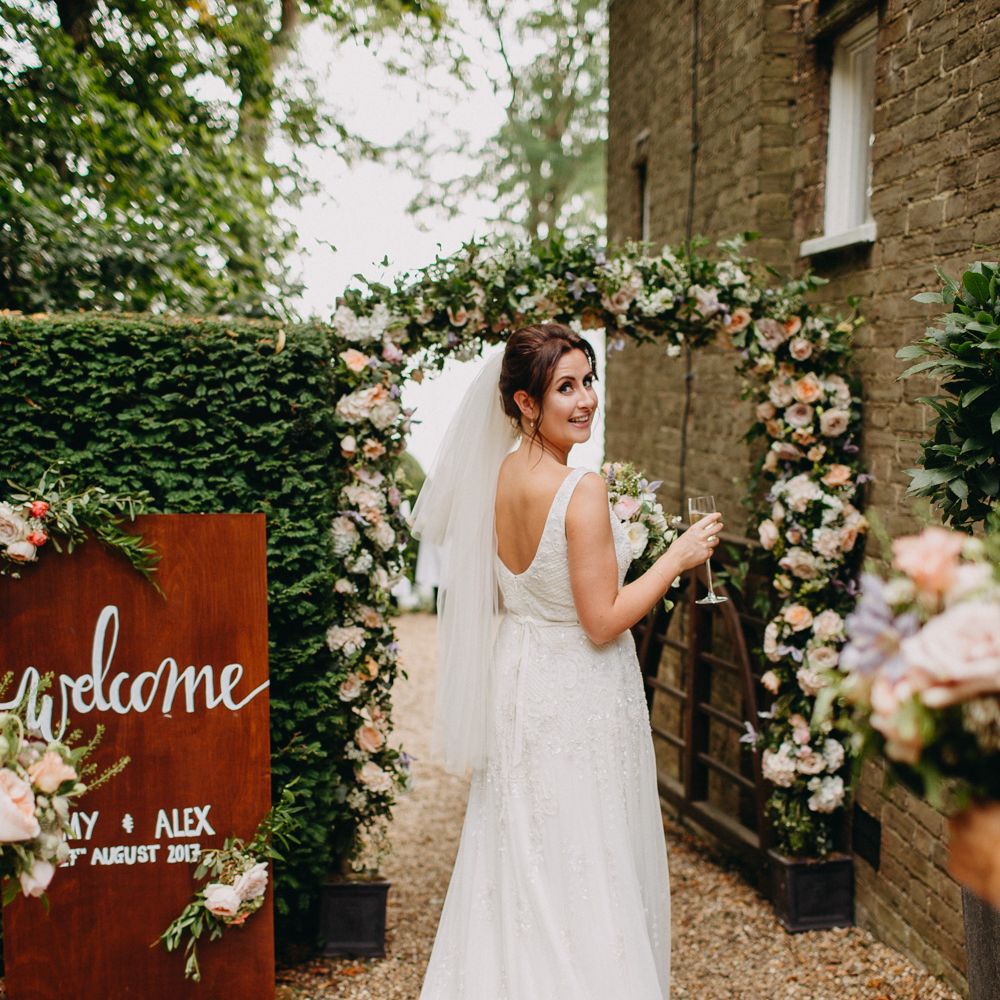 Floral Arch from Topiary Tree | Church Wedding Ceremony | Bride in Karen Willis Holmes | Groom in Custom Made Suit by Suit Supply | Summer Wedding at Family Home in Kent | Glass Marquee from Academy Marquees | Frances Sales Photography