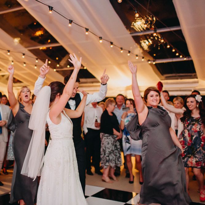 Marquee at Night | Festoon Lights from Stress Free Hire | Flowers from Topiary Tree | Bride in Karen Willis Holmes | Groom in Custom Made Suit by Suit Supply | Summer Wedding at Family Home in Kent | Glass Marquee from Academy Marquees | Frances Sales Photography