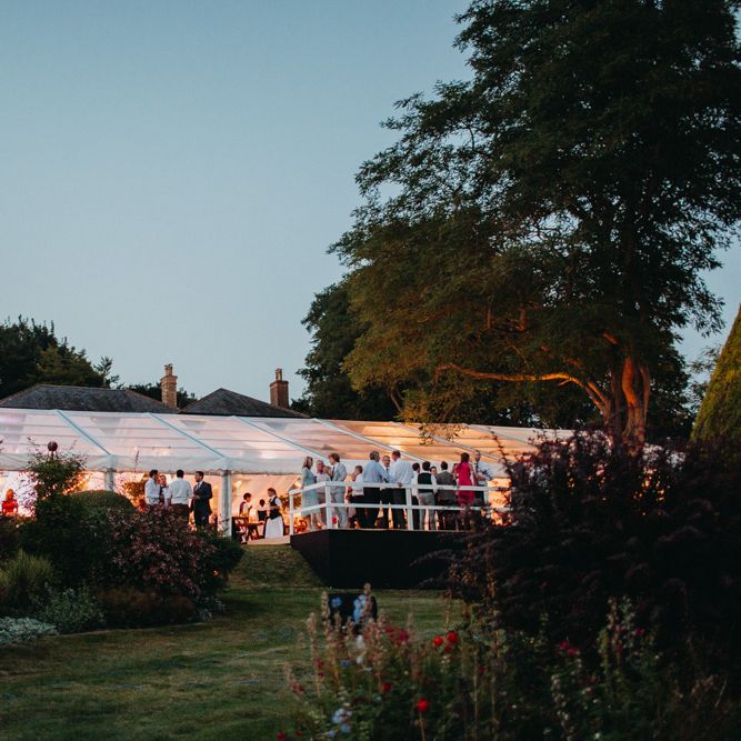 Marquee at Night | Flowers from Topiary Tree | Bride in Karen Willis Holmes | Groom in Custom Made Suit by Suit Supply | Summer Wedding at Family Home in Kent | Glass Marquee from Academy Marquees | Frances Sales Photography