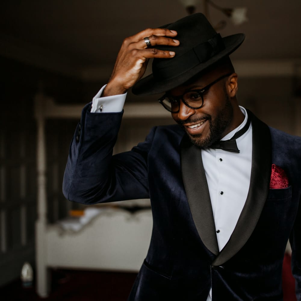 Stylish groom in Fedora hat