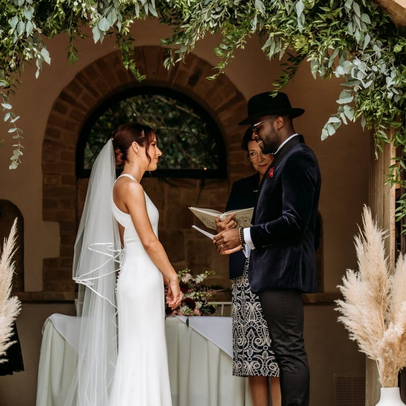 Bride and groom exchanging vows at The Ravenswood wedding ceremony