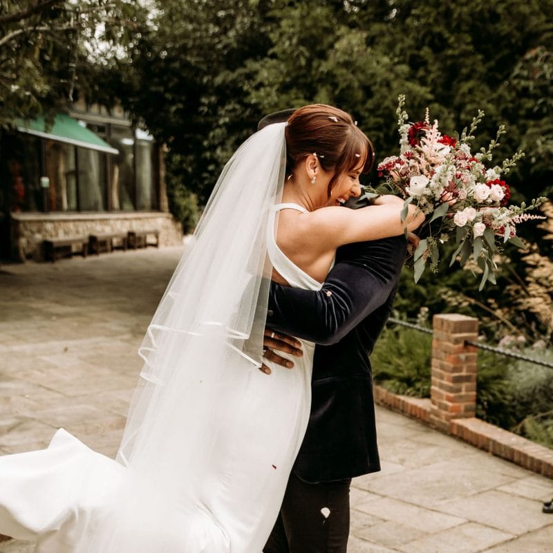 Groom picking up his bride with joy