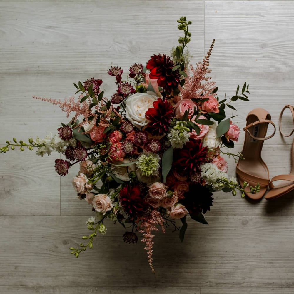 Pink and red flower wedding bouquet and bridal shoes