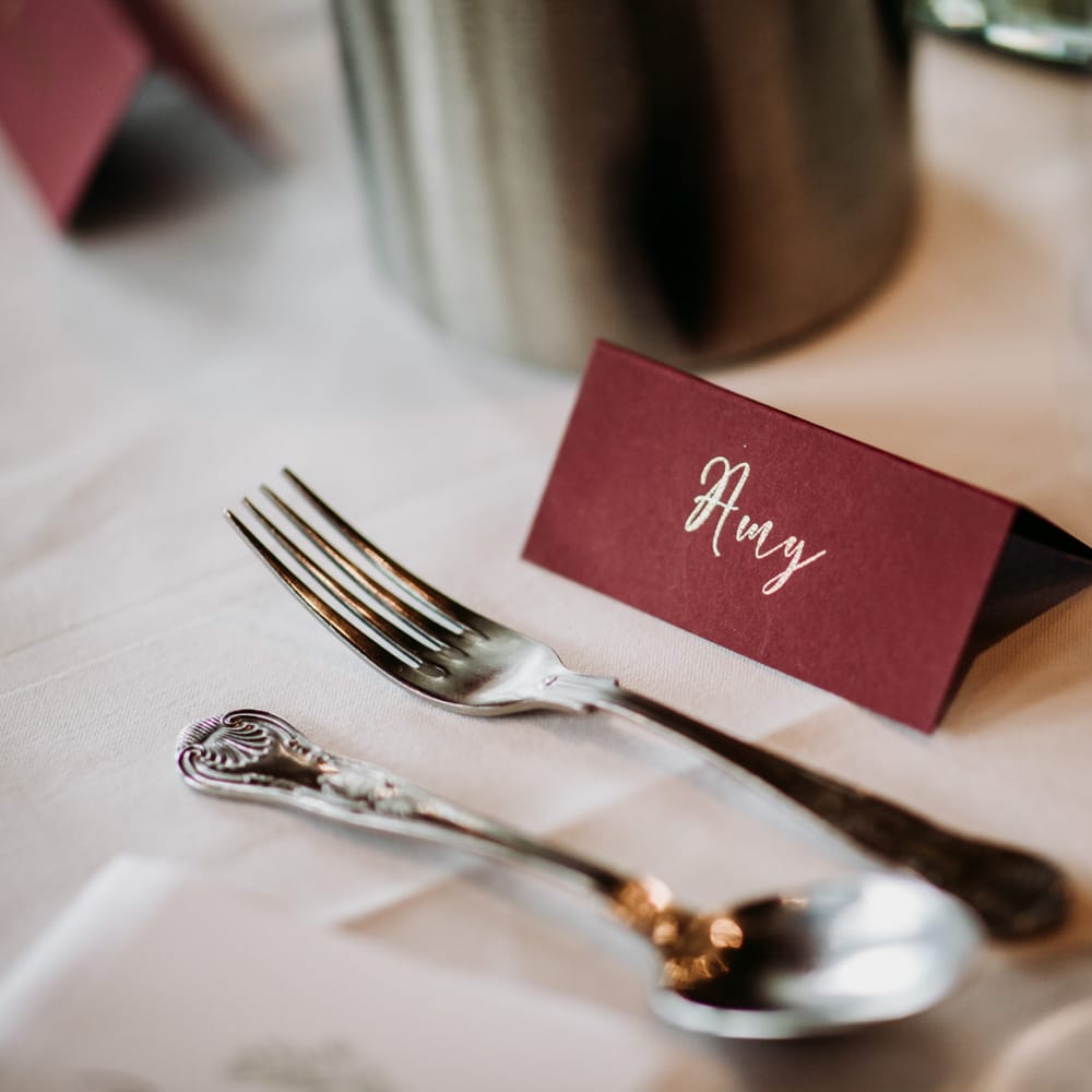 Burgundy name place card with gold font