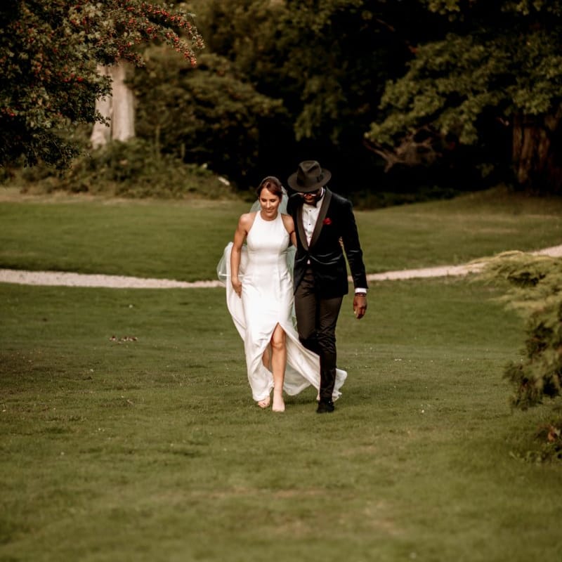 Stylish bride and groom walking arm in arm