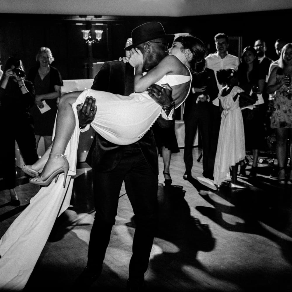 Groom sweeping his bride off her feet at The Ravenswood evening reception