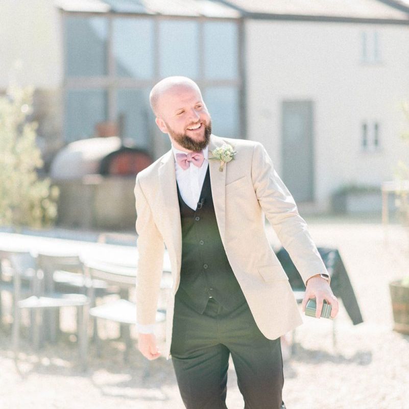 Groom in Black Chino's and Beige Blazer with Bow Tie and Tan Loafers