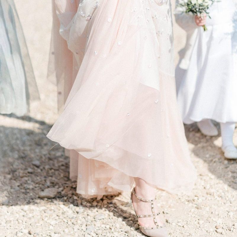 Bride in Pink Ombre Needle &amp; Thread Wedding Dress Holding Up Her Tulle Skirt To Reveal Her Valentino Rock Stud Shoes