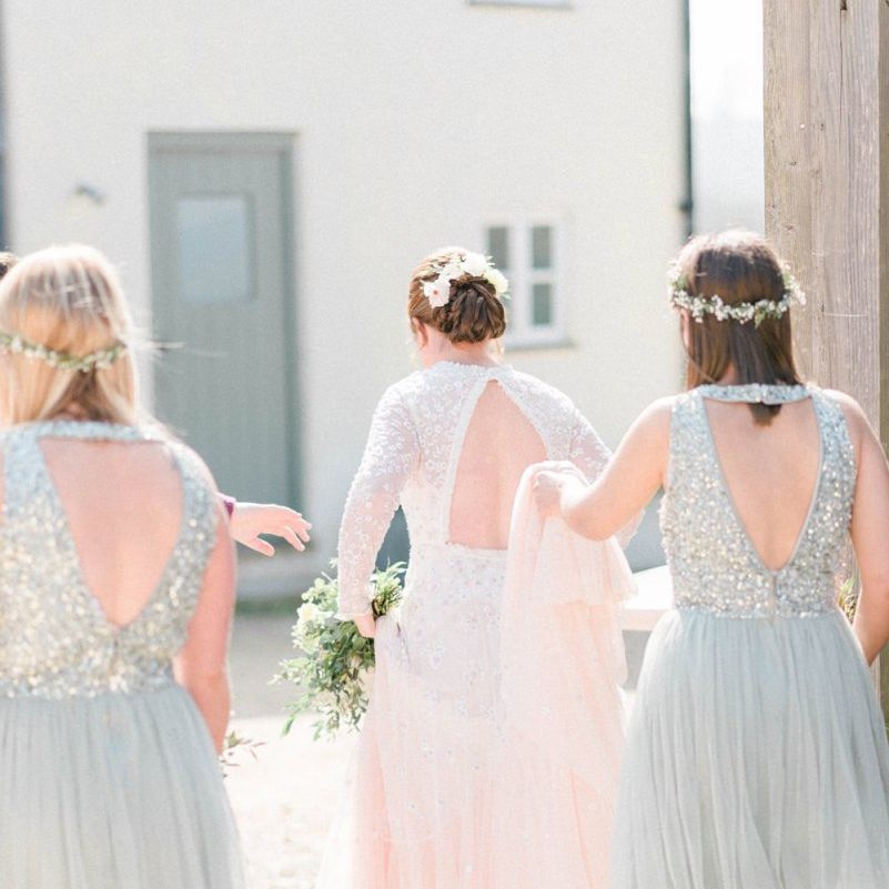 Bridesmaids in Sequin and Tulle Dresses Holding the Brides Train