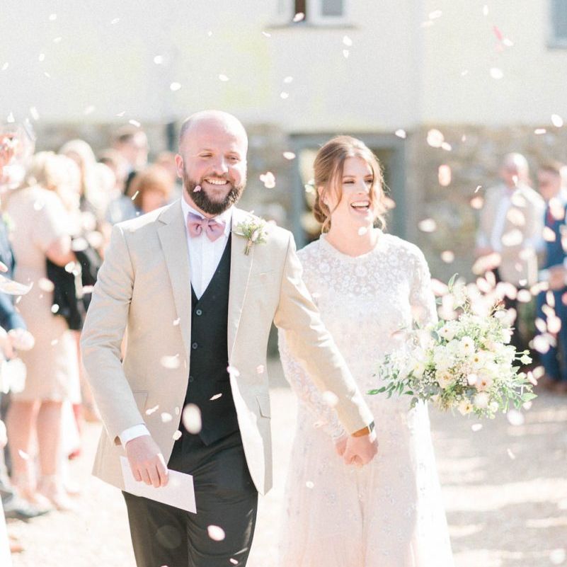 Confetti Moment with Bride in Needle &amp; Thread Ombre Wedding Dress and Groom in Beige Blazer and Pink Bow Tie